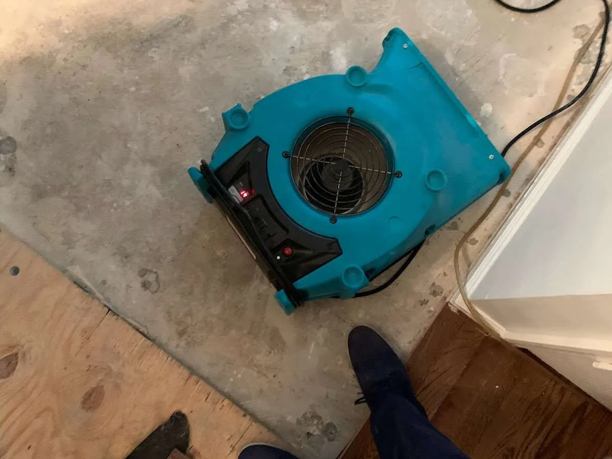 Air mover drying subfloor during Leak Detection & Repair in Tupelo